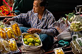 Thailand, Locals sell fruits, food and products at Damnoen Saduak floating market near Bangkok 